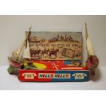 Two old painted wood red and green model pond yachts and two boxed games (1 box)