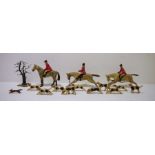 Vintage wooden models of huntsmen and hounds to include, horses, hounds, riders and foliage (1