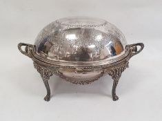 Silver plated breakfast dish of usual oval form with revolving cover decorated with floral swags,