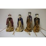 Set of four Eastern painted wood puppet dolls, each on a stand and with arms operated by wooden