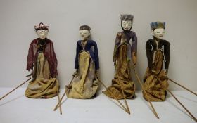 Set of four Eastern painted wood puppet dolls, each on a stand and with arms operated by wooden