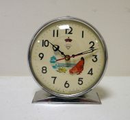 Chrome and green metal keywind clock with animated pecking chicken to the dial, marked 'Shanghai,