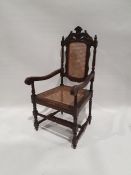 Early 20th century armchair with carved oak frame, with caned seat and back, turned and block