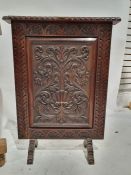 20th century oak firescreen with carved scrollwork decoration