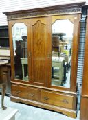 Early 20th century two-door mahogany wardrobe, the moulded cornice with blind fretwork carving,