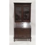 Early 20th century oak bureau bookcase with leaded glazed doors above fall and three drawers, on