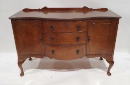 Early 20th century walnut serpent-fronted sideboard with three short drawers to centre flanked by