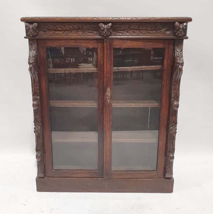 20th century carved oak glazed bookcase on plinth base  Condition ReportHeight 105cm Width 89cm