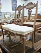 Pair of bedroom chairs with carved and shaped backsplats, cream upholstered seats, on cabriole legs,