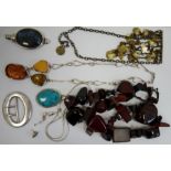 Silver coloured wirework necklace set with three amber nuggets, a silver buckle of plain oval form