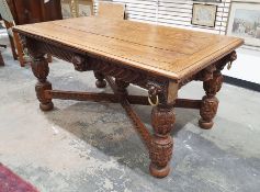 Early 20th century oak draw-leaf table in the Victorian Gothic taste, the base with lion masks,