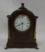 19th century mahogany-cased mantel clock with Roman numerals to the dial, inlaid shell decoration,