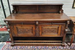 Heavy carved oak Renaissance style sideboard, the shelved tier with carved backboard decoration, the