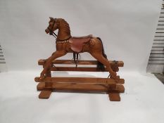 Modern pine platform rocking horse with leather saddle