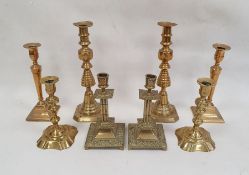 Pair of brass candlesticks of square form with mask and floral decoration, 20cm high and three