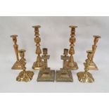 Pair of brass candlesticks of square form with mask and floral decoration, 20cm high and three