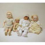 Two composition baby dolls, a bisque headed baby doll with painted features and a composition doll
