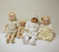 Two composition baby dolls, a bisque headed baby doll with painted features and a composition doll