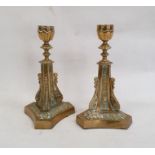 Pair of brass candlesticks on triform bases with scroll and floral decoration, 22cm high (2)