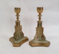 Pair of brass candlesticks on triform bases with scroll and floral decoration, 22cm high (2)