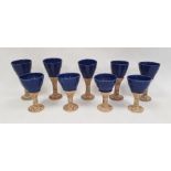 A set of studio pottery goblets with blue glazed bowls and incised decorated stems (9)