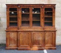 Victorian rosewood breakfront bookcase, frieze carved with beaded decoration over four glazed doors,