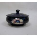 Moorcroft lidded powder bowl with blue ground floral decoration, oblate, with paper label 'W