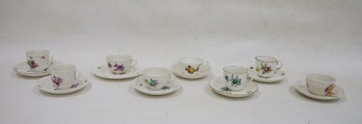 Seven assorted Nymphenburg cabinet teacups and saucers, each with foliate decoration, and one
