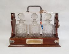 Late 19th/early 20th century mahogany tantalus with silver plated mounts and ,locking mechanism