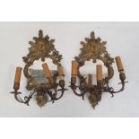 Pair of three-branch girandole wall mirrors, the brass frames with mask decoration, 44cm high (2)