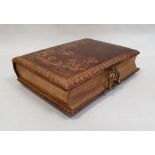 Victorian tooled leather musical photograph album, the cover decorated with waterlilies, the