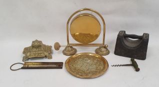 Brass table gong, a brass inkwell of square form with scrolling floral decoration and various