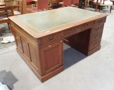 Partner's pedestal mahogany desk with green leather writing surface, with assorted drawers and