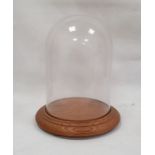 Modern glass dome on circular wooden base, 37cm high