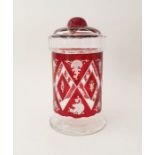 An early 20th century Bohemian ruby red cut glass lidded jar with etched diamond and scrollwork