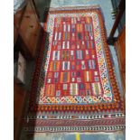 Modern Eastern-style rug with red ground central field in whites, oranges, blues, greens and reds