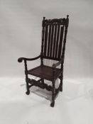 20th century armchair with carved top rail above slatted back, carved arm rests, turned, carved