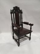 Late 19th/early 20th century armchair, the top rail carved with lions bearing shield, leather