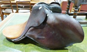 Three brown leather saddles (3)
