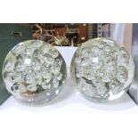 Pair of modern large round glass paperweights together with a box of books