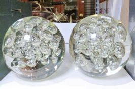 Pair of modern large round glass paperweights together with a box of books
