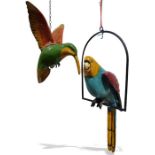 Papier mache model of a parrot, a papier mache model of a hummingbird and a wooden model of a