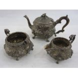 Georgian silver teaset, milk jug and sugar bowl with embossed floral decoration, the C-scroll