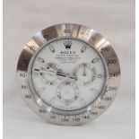 WITHDRAWN Modern wall clock in the form of a Rolex Oyster Perpetual Daytona wristwatch, 33cm