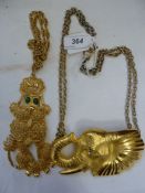 Modern large gilt metal elephant head necklace marked 'DR 94' and a gilt metal articulated poodle