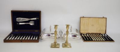 Pair of lidded silver-plated tureens, a pair of brass candlesticks, a boxed set of cake knives and