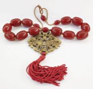 Oriental red amber coloured bead and brass necklace having red turned amber-coloured beads with