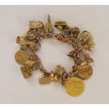 Rose gold-coloured curb link charm bracelet having multiple charms, including 19th century gold-