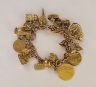 Rose gold-coloured curb link charm bracelet having multiple charms, including 19th century gold-