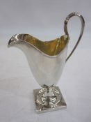 Silver pedestal cream jug in Georgian-style, tall helmet-shaped with reeded edge and reeded